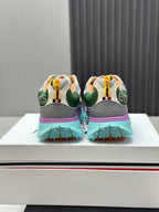 Back view of two-tone sneakers with mint tread sole and purple heel accents.