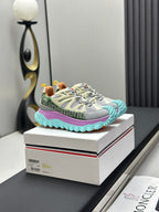 Light grey lace-up sneakers with purple panel and turquoise tread sole.