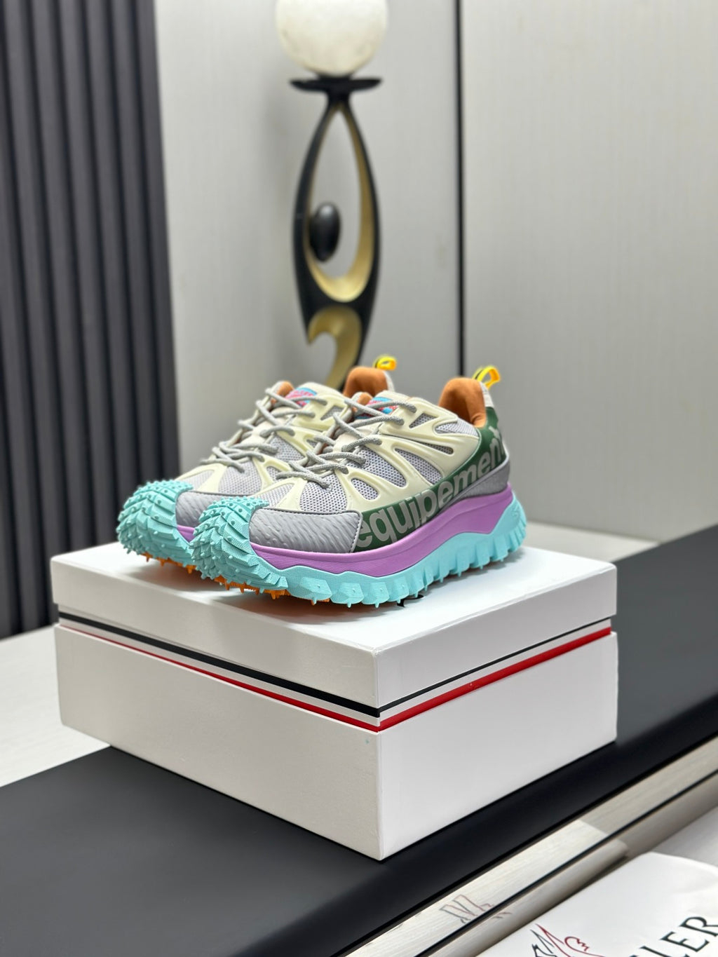 Grey trail sneakers with mint rubber sole and purple side stripe, lace-up.