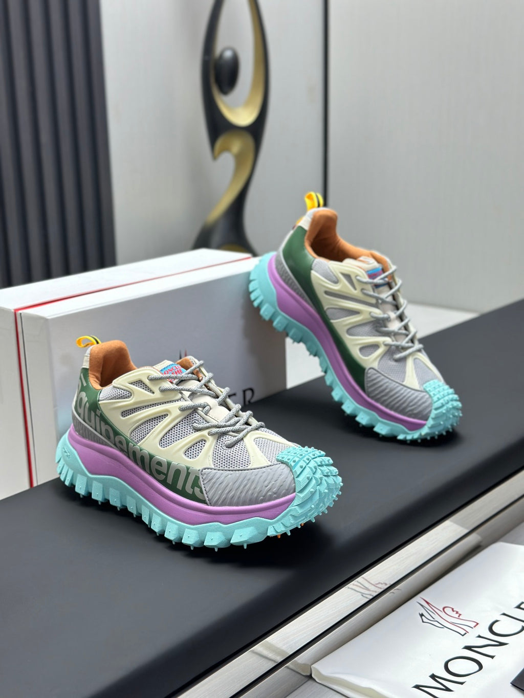 Pair of grey sneakers with purple midsole and mint textured outsole.