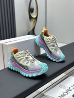 Pair of grey sneakers with purple midsole and mint textured outsole.