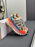Moncler trail sneaker with white laces, orange inset and pink sole edge, side logo detail