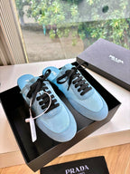Pair of Prada women's light blue lace-up sneakers with black laces and rubber sole