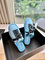 Prada women's light blue lace-up sneakers, angled side view with black laces