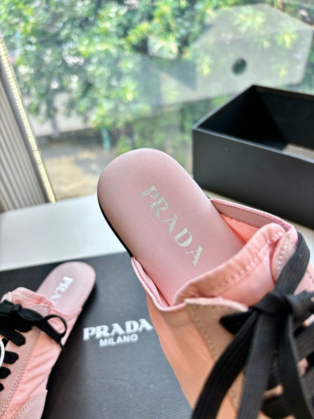 Prada lace-up sneakers for women, close-up of pink insole with black lace-up upper