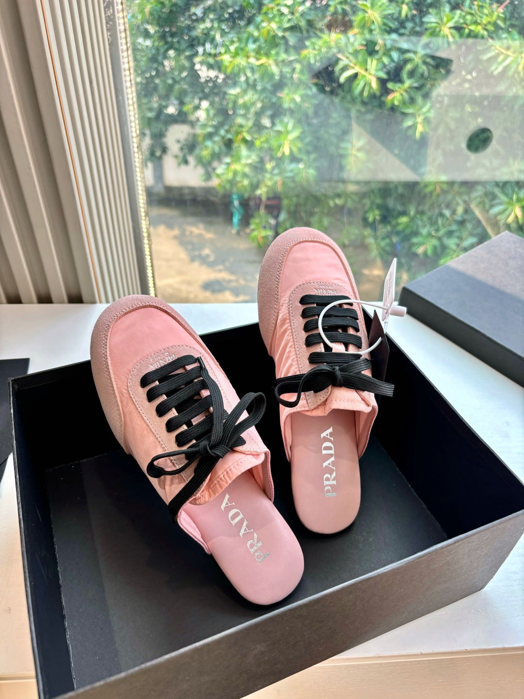 Prada lace-up sneakers for women, pink suede uppers with black laces, side view