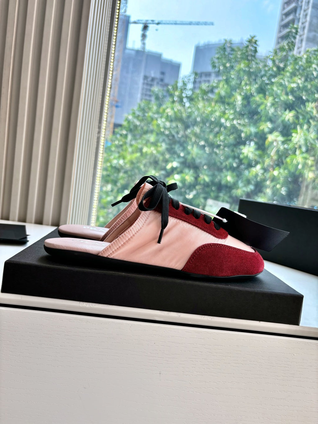 Prada women's sneakers on box, blush pink and burgundy with black lace-up
