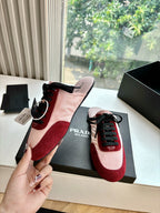 Prada women's sneaker in hand, blush pink and burgundy suede with black laces