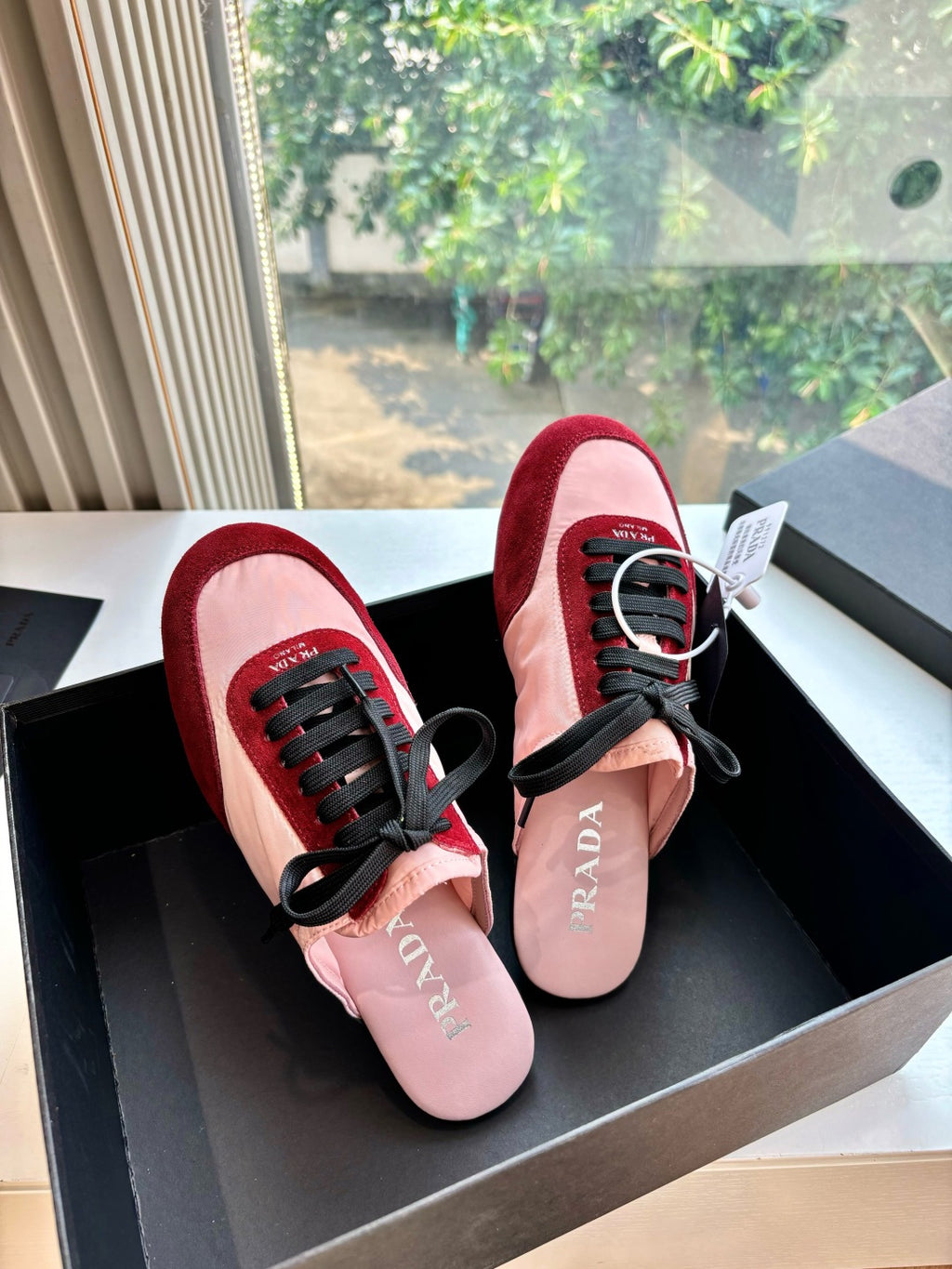 Prada women's sneakers, burgundy trim and blush pink uppers with black laces