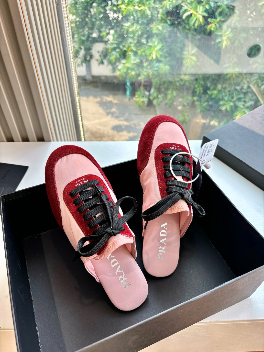 Prada women's sneakers, burgundy trim and blush pink uppers with black laces