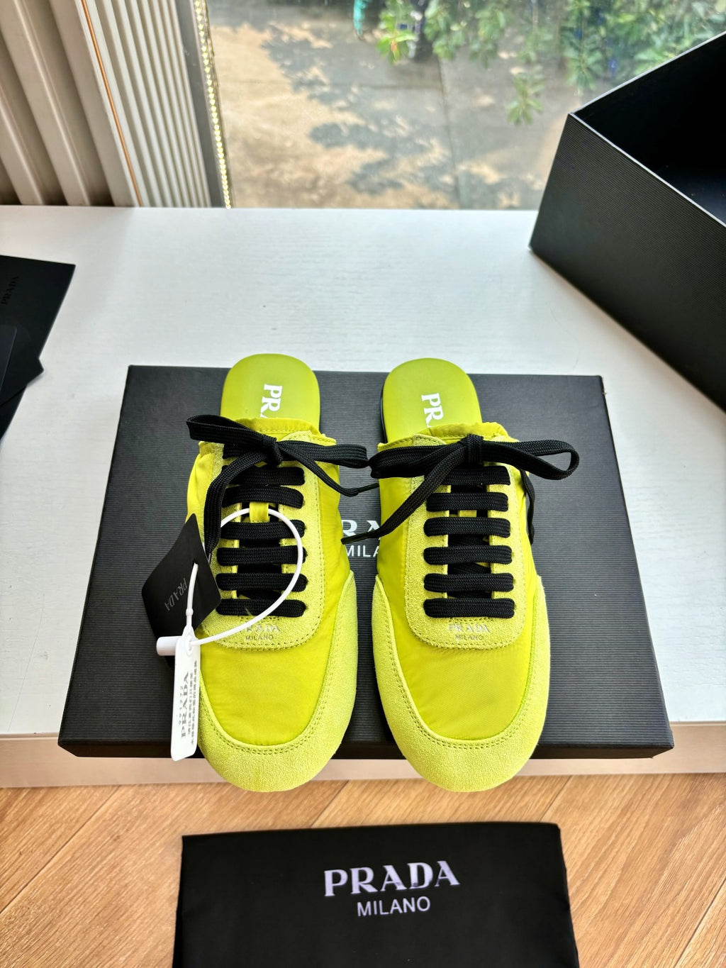 Neon yellow lace-up sneakers with black laces, padded collar, Prada MILANO text