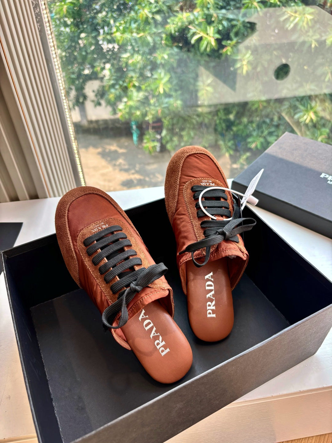 Prada low-top sneakers, tan upper with black lace-up and textured side panels