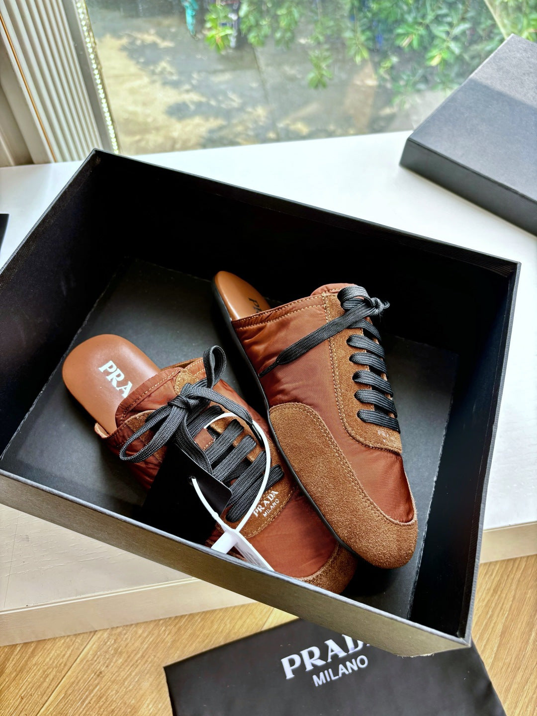 Prada low-top sneakers in tan suede with black laces and contrast stitching