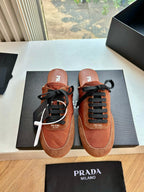 Prada low-top sneakers in tan suede with black laces and contrast piping