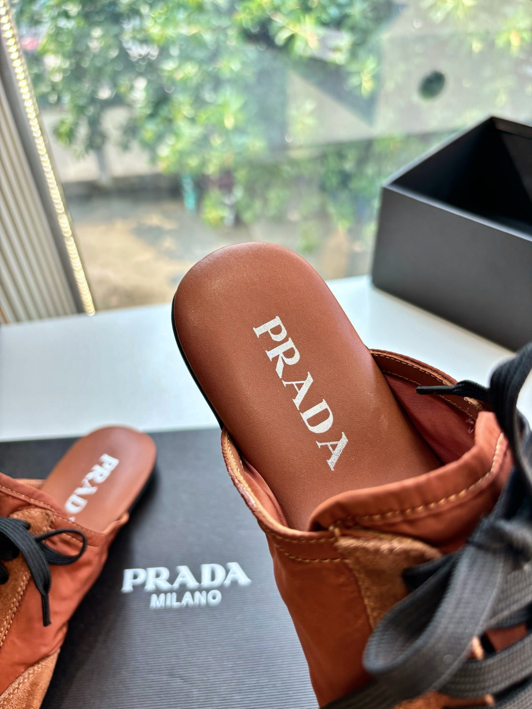 Prada sneaker heel with PRADA label, tan lining and black lace-up detail