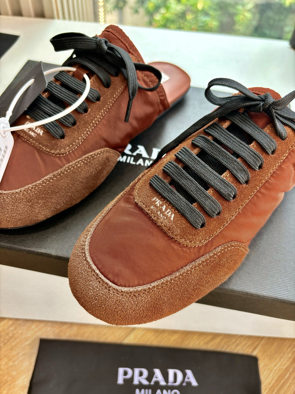 Prada low-top sneakers, tan and brown suede with black laces and round toe