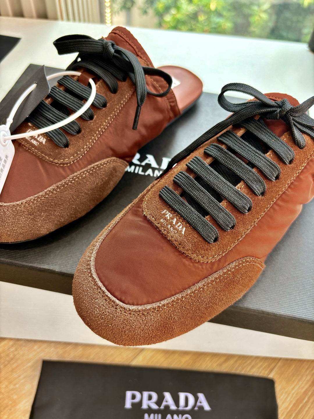 Prada low-top sneakers, tan and brown suede with black laces and round toe