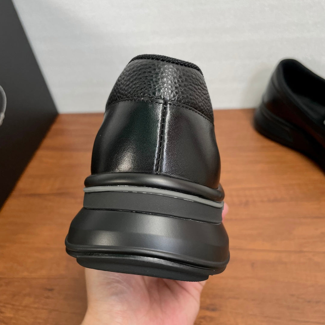 Prada unisex black leather loafer heel view, with rubber sole edge detail