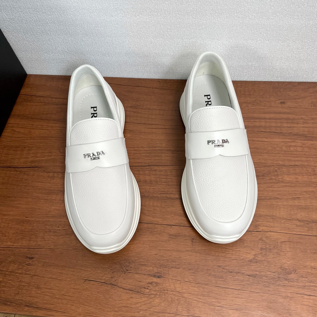 Pair of white Prada unisex slip-on sneakers with logo on tongue