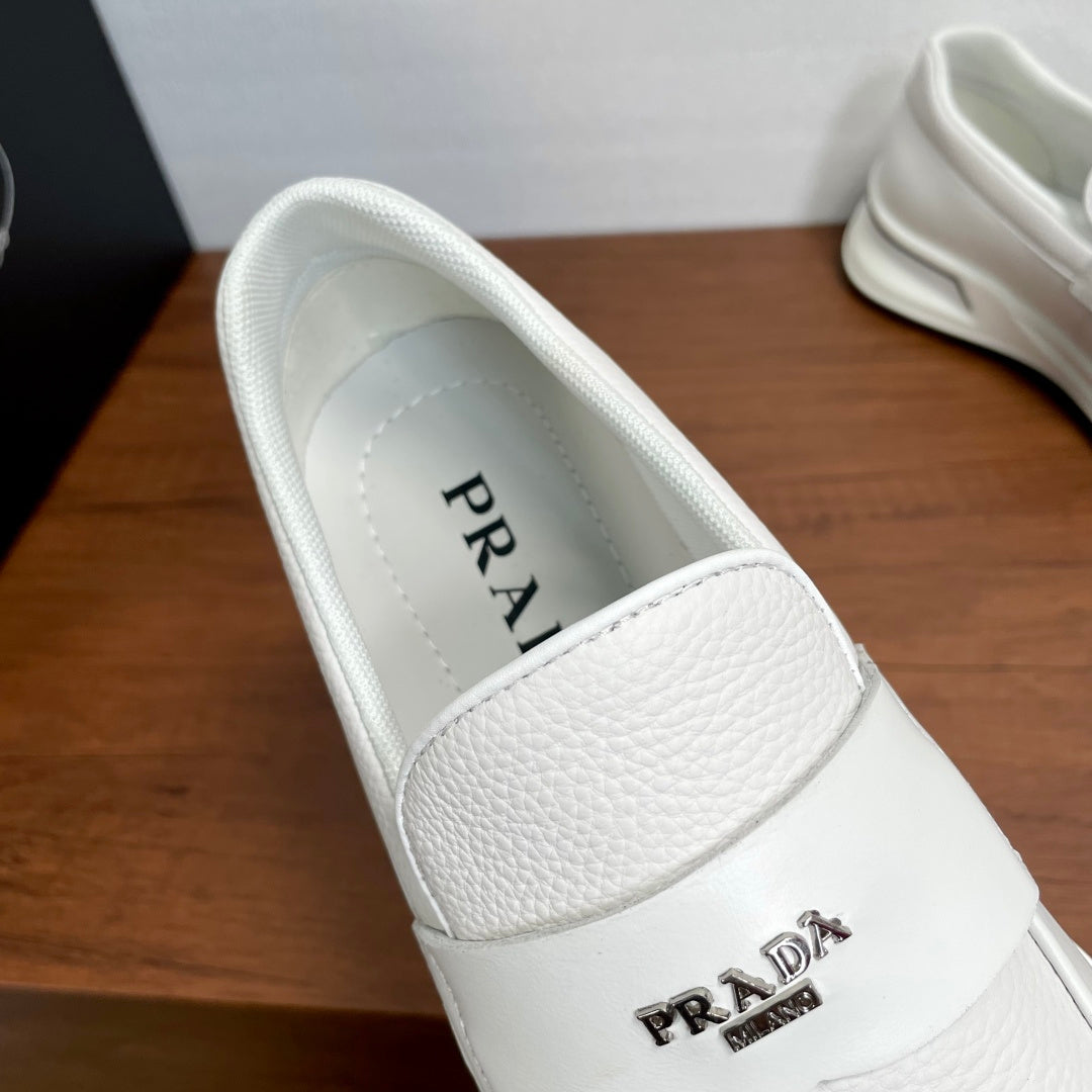 White Prada unisex slip-on sneaker showing logo on upper