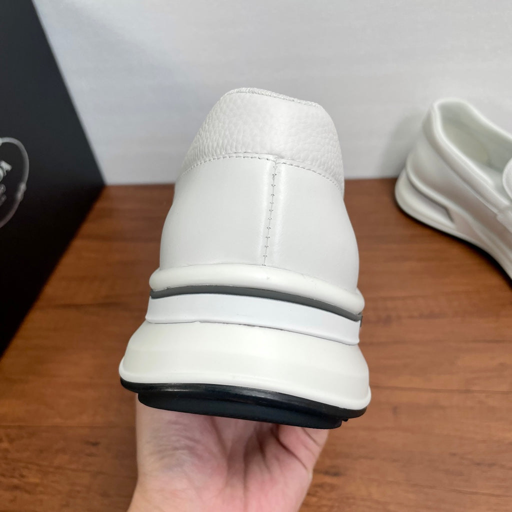 White Prada unisex slip-on sneakers back view with cushioned heel