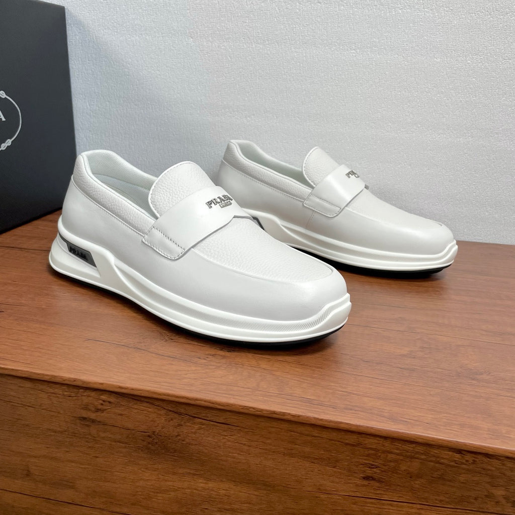 White Prada unisex slip-on sneakers on display with side logo