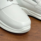White Prada unisex slip-on sneaker front close-up with rubber sole