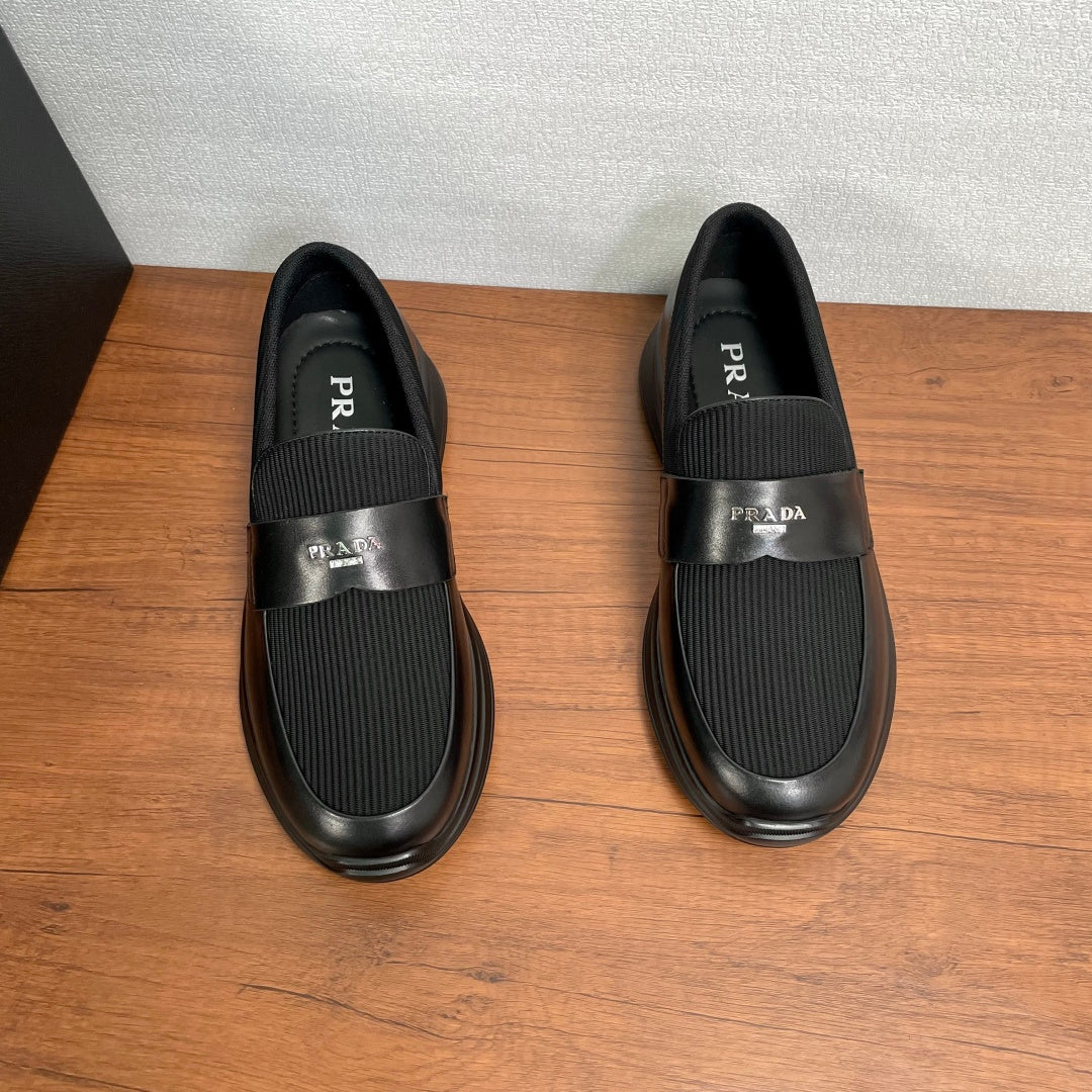 Prada unisex loafers, front and back view; black slip-on with ribbed elastic panels