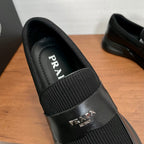 Prada unisex loafers instep view, black leather with ribbed elastic and PRADA logo strap