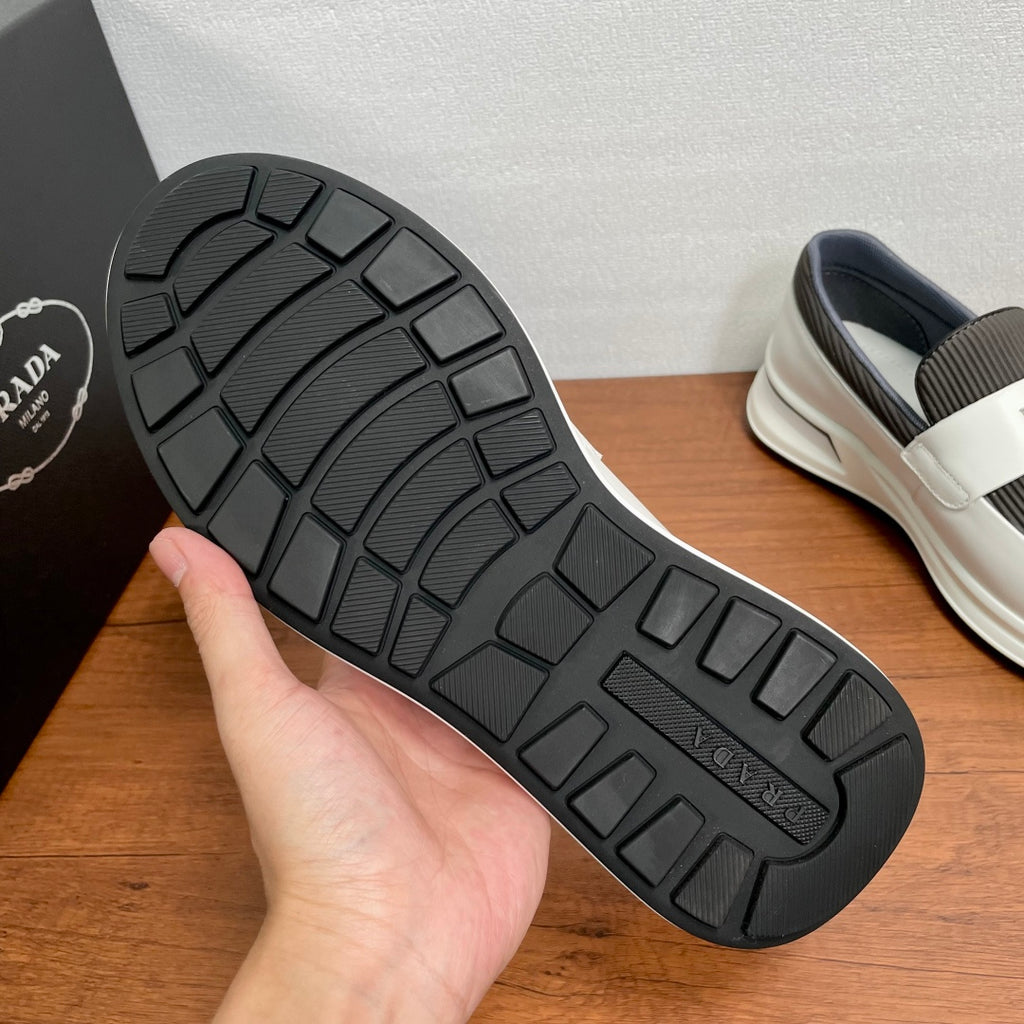 Outsole of white slip-on sneakers with black tread pattern