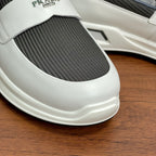 Close-up of white slip-on sneaker toe with gray elastic insert and logo