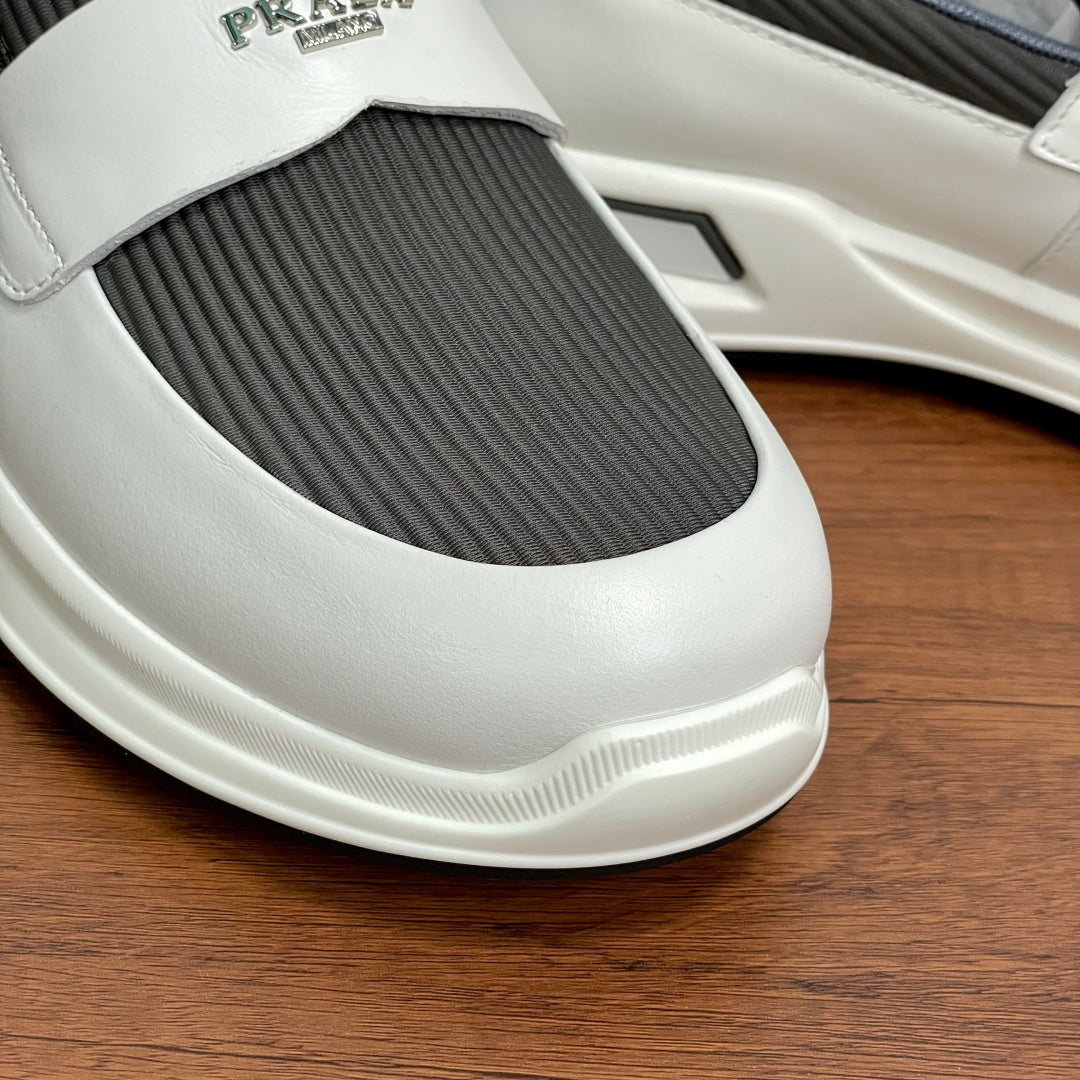 Close-up of white slip-on sneaker toe with gray elastic insert and logo