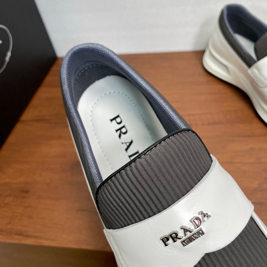 White slip-on sneakers with gray collar and PRADA on insole