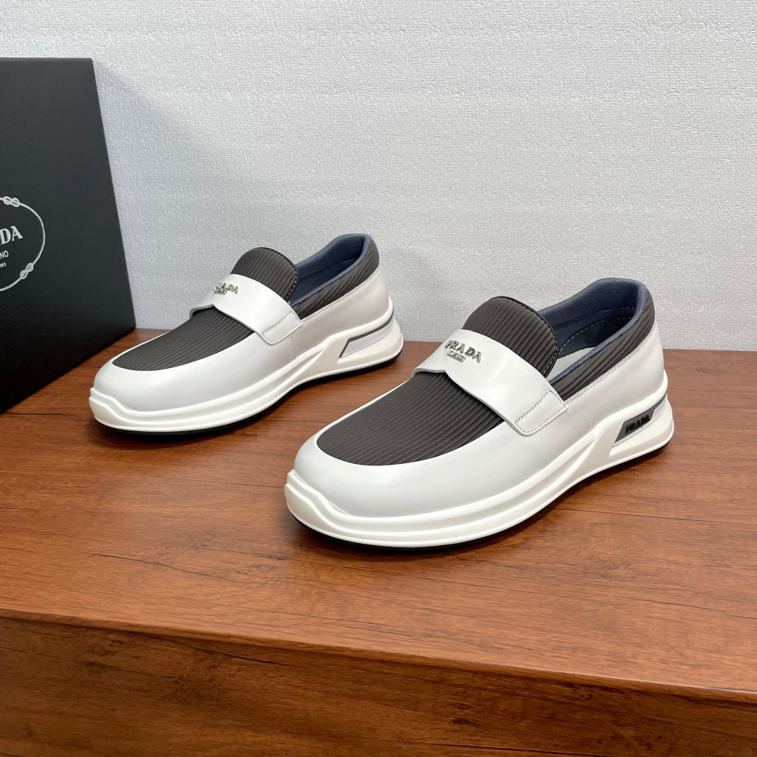 Prada white slip-on sneakers with gray elastic side panels and cushioned sole
