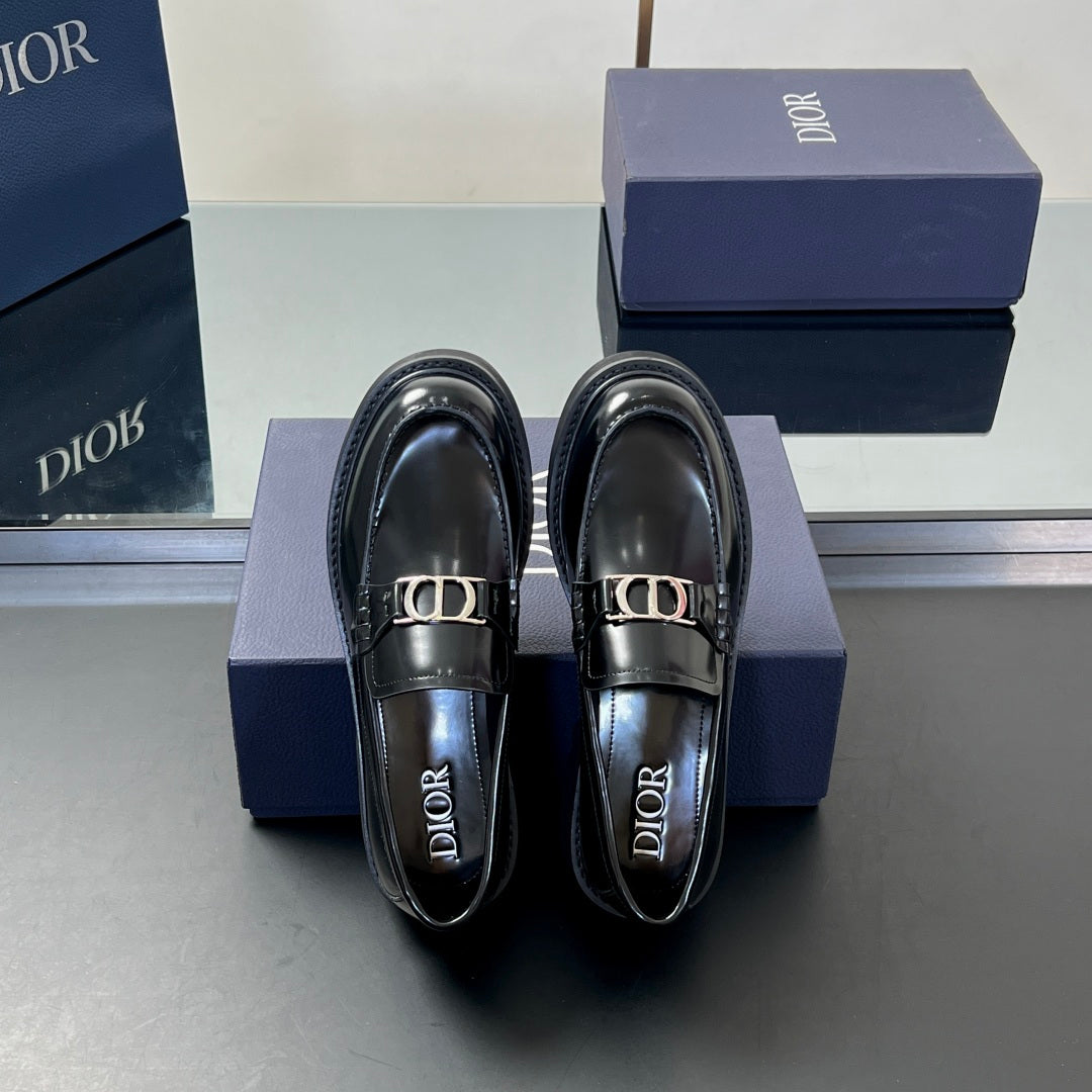 Black leather unisex loafer pair facing front with Dior logo buckle