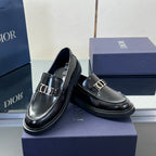 Black leather unisex loafer pair with Dior buckle and glossy finish