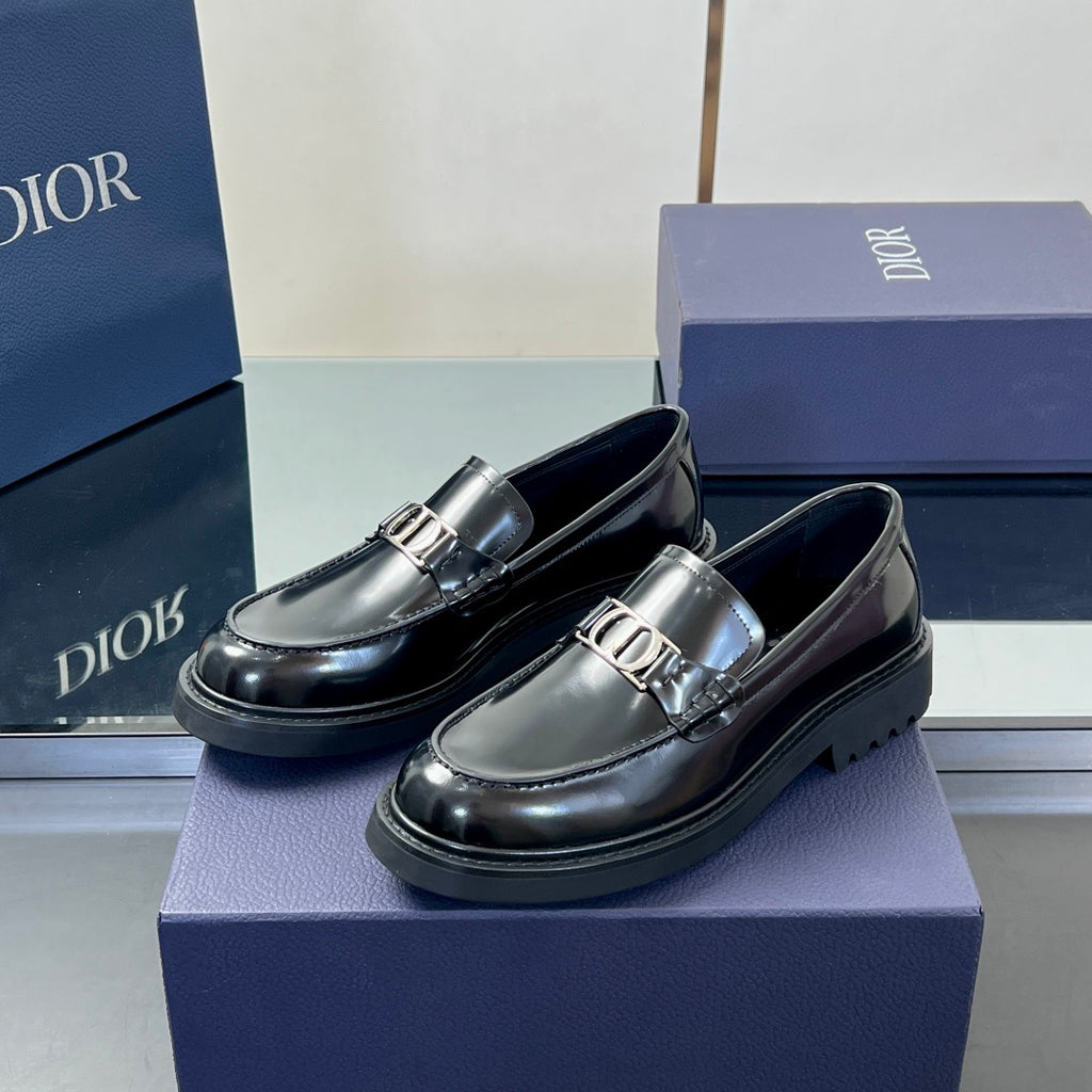 Black leather unisex loafer pair with Dior buckle strap and low sole
