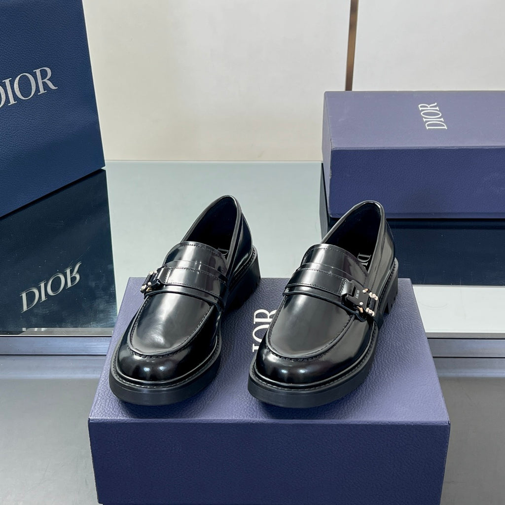 Black leather unisex loafers with front strap and metal buckle, low chunky sole
