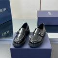 Black leather unisex loafers with front strap and metal buckle, low chunky sole