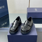 Black leather unisex loafers with front strap and metal buckle, low chunky sole