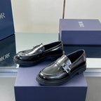 Black leather unisex loafers with front strap buckle and low platform sole