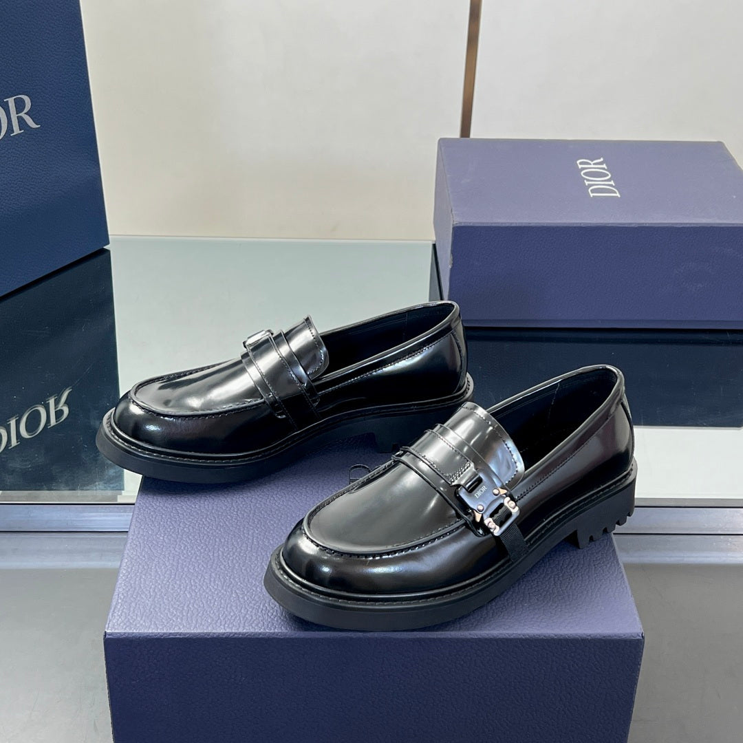 Black leather unisex loafers with front strap buckle and low platform sole
