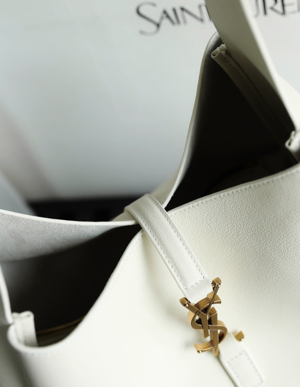 YSL bag white leather corner with gold clasp detail and stitched strap.