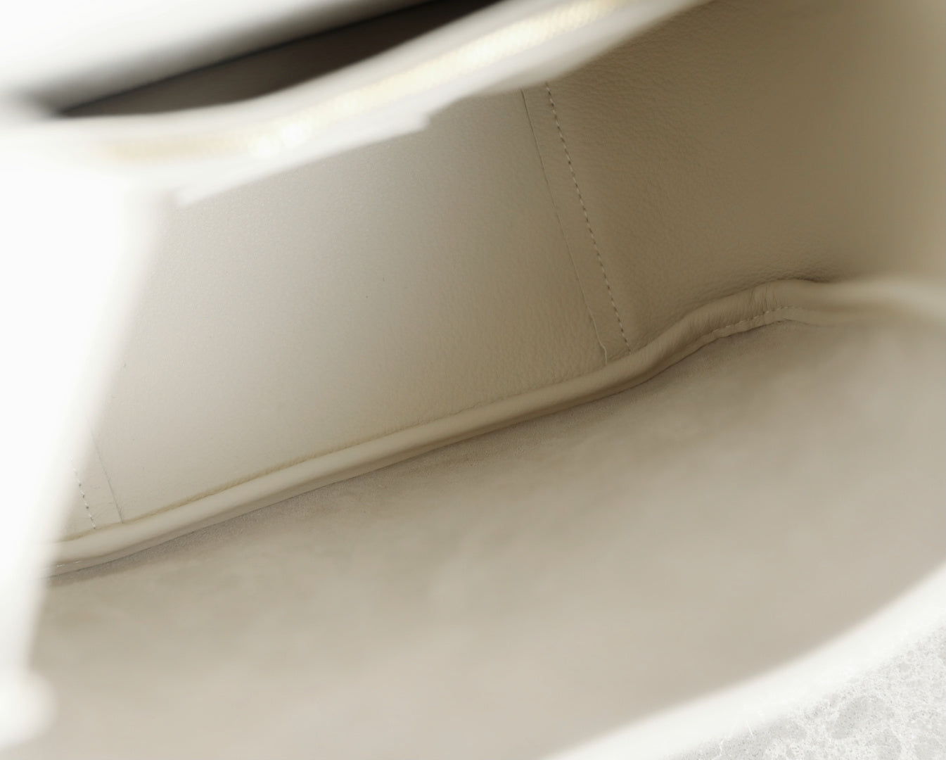 YSL bag white leather interior seam and reinforced edge close-up.