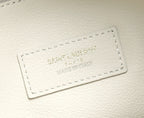 YSL bag white leather label with embossed branding and stitched border.