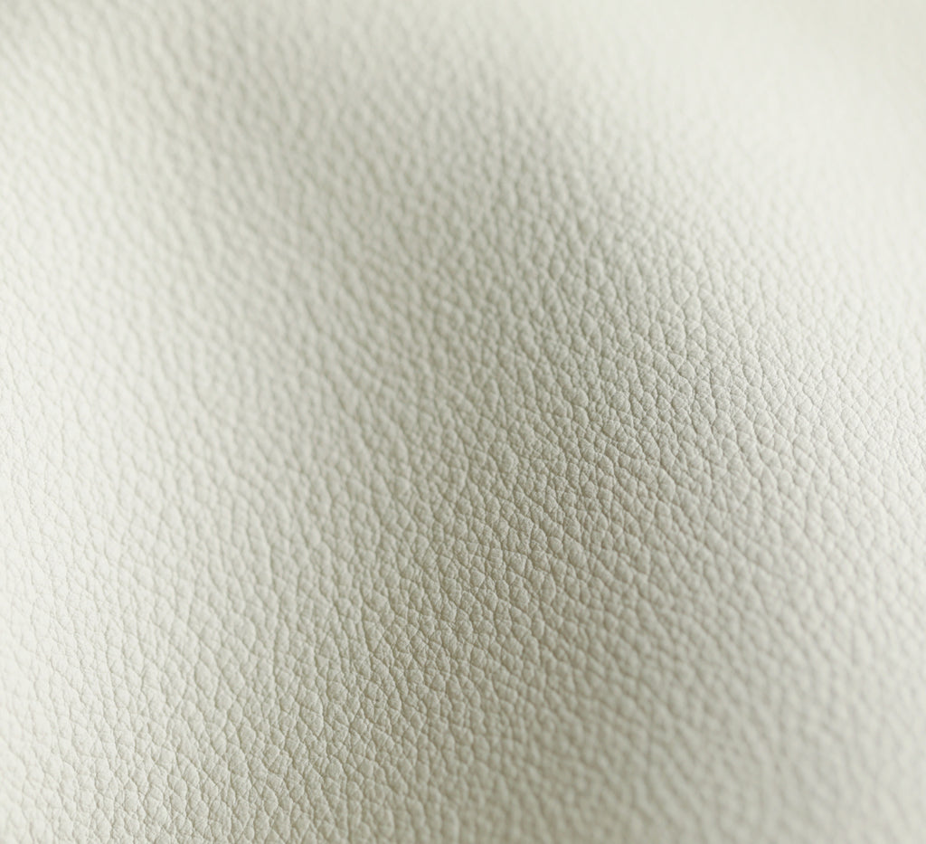 YSL bag white leather texture close-up, pebbled grain and stitching visible.