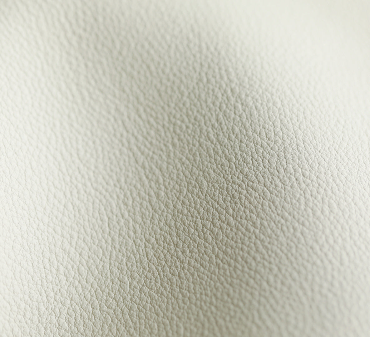 YSL bag white leather texture close-up, pebbled grain and stitching visible.