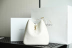 YSL bag in white leather with gold hardware and drawstring top.