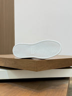 White sneaker outsole with textured tread pattern, viewed from below