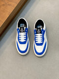 Blue and white low-top lace-up sneakers, pair side view with logo on heel and tongue